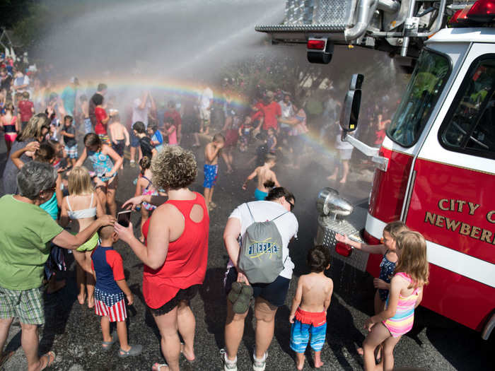 Amid the scorching heat, some families found creative ways to cool off — from sprinklers to actual fire hoses.