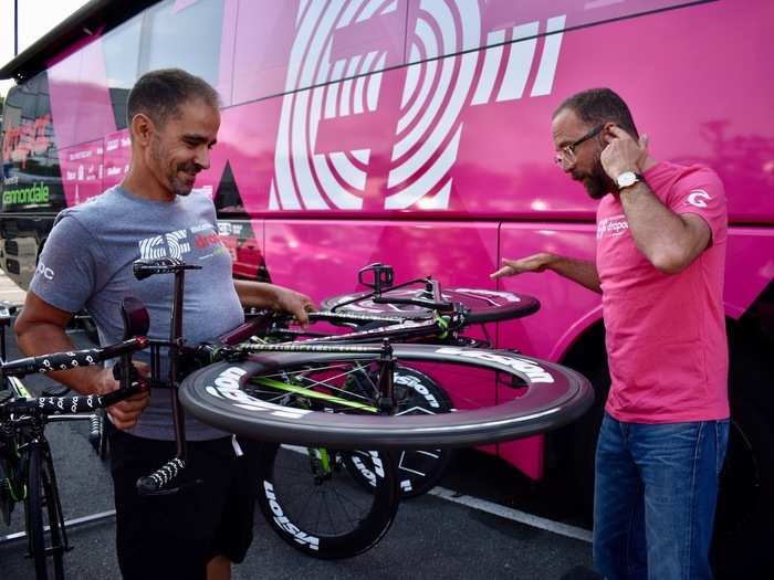 Jorge Queiros, a mechanic from Portugal, was checking to make sure the brakes were working properly and the wheels were spinning fast, while team boss Jonathan "DJ JV" Vaughters of the US did some spinning of his own.