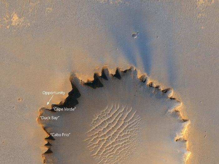 Opportunity saddled up to the Victoria crater, which is five times wider than the Endurance crater, on September 26, 2006. In this image, the rover appears as a tiny speck on the rim.