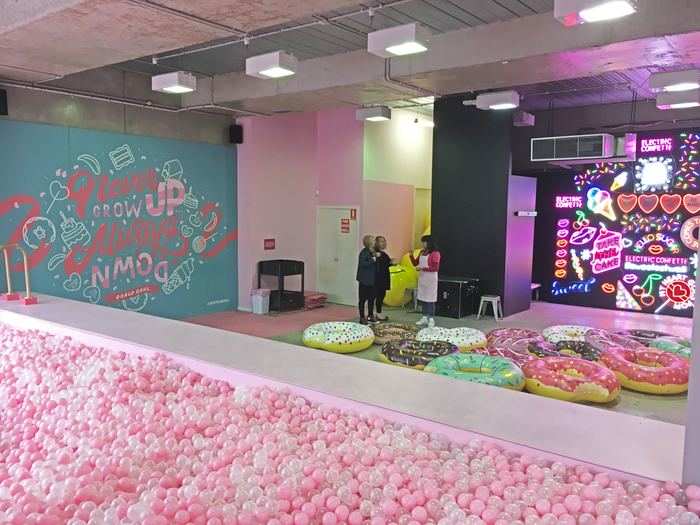 Which is the room filled with blow-up donuts, a neon light wall, and a massive ball pit.