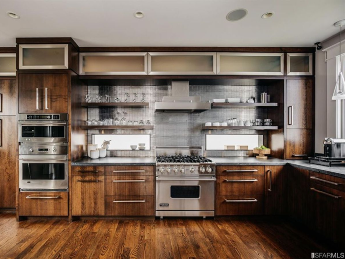 The dark wood finishes in the kitchen mirror that of the home