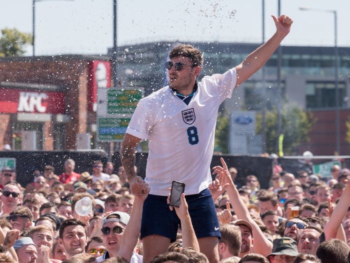 It is unclear whether this fan is having a beer shower.