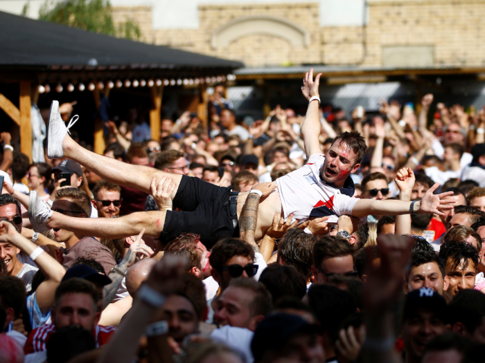 One fan gets passed around like a ball at an England match.