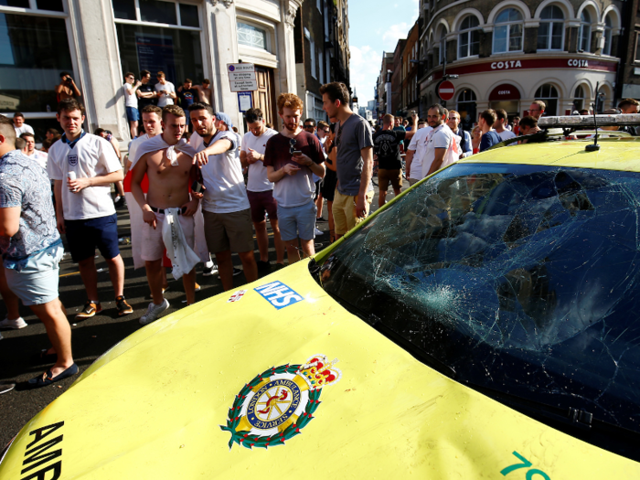 ... as this ambulance suffered some serious damage after fans started climbing on it.