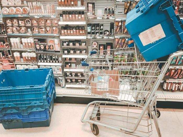 The shelves themselves were well stocked and organized, but there were carts and blue bins everywhere, blocking the aisle.
