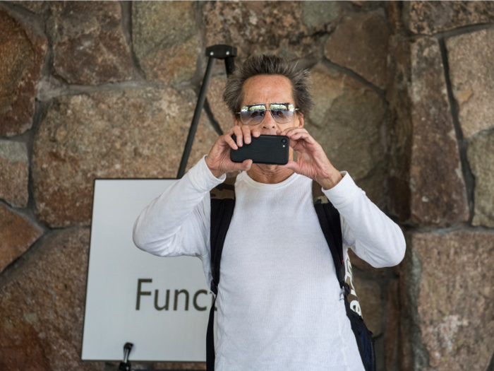 Brian Grazer, founder of Imagine Entertainment, also takes a moment to take a photo of the press.