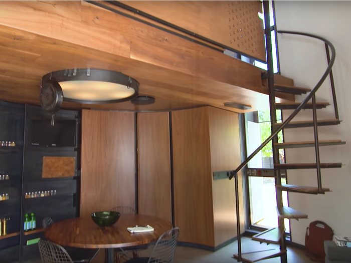 And feet away from both the kitchen and bathroom is a winding staircase leading to the upstairs bed loft.