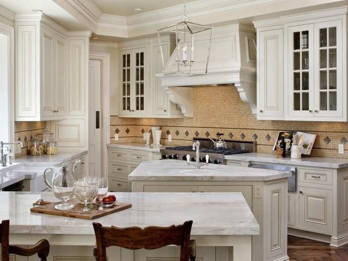 The kitchen is decked out in white finishes and granite countertops.