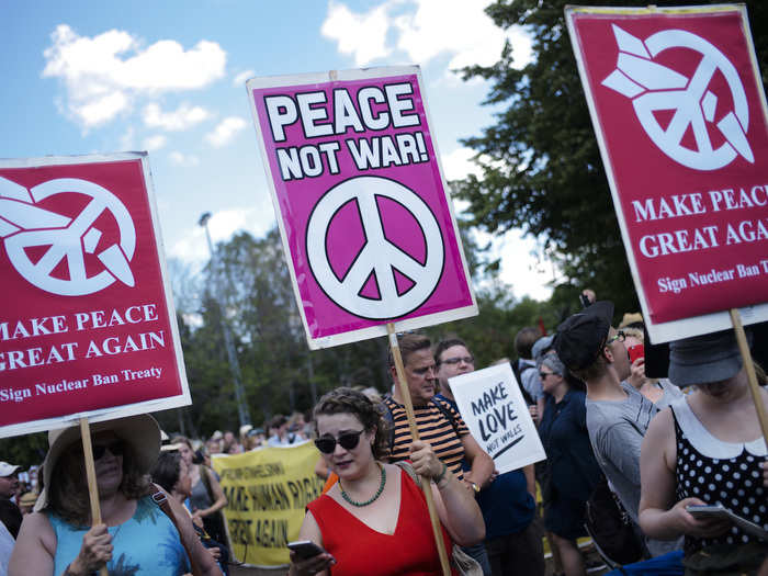 Some protesters waved rainbow flags, while others held signs that read "make human rights great again," and "make peace great again," playing off Trump