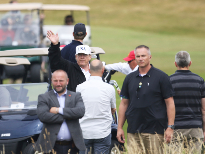 Trump gave the protesters and onlookers a wave.