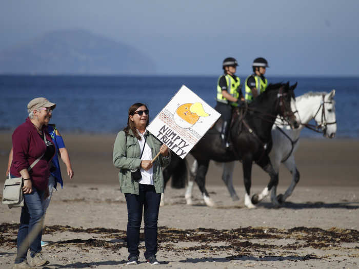 And a small crowd of at least a dozen protesters carrying signs showed up on a nearby beach.