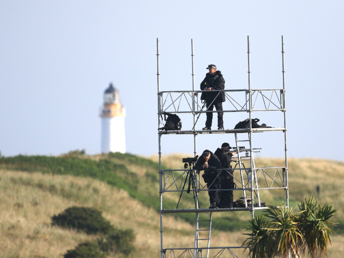 Snipers patrolled the seaside resort from above as Trump golfed.