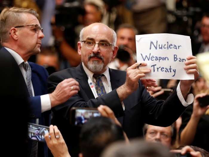 Next up was a joint press conference. A man who identified himself as a journalist from the US-based publication The Nation was asked to leave the room, but re-entered to collect his things and held up a sign that said "nuclear weapon ban treaty".