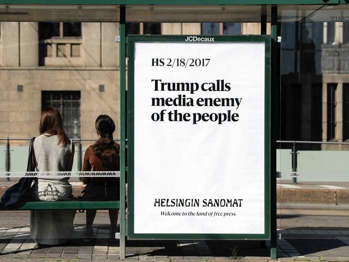 Protest ads were hung around the city, including this one at a Helsinki bus stop that features a February headline from a Finnish newspaper. Trump tweeted the same phrase again on Sunday.