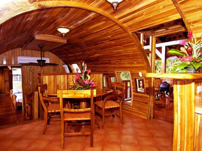 The carved-out fuselage home is outfitted with teak panelling that