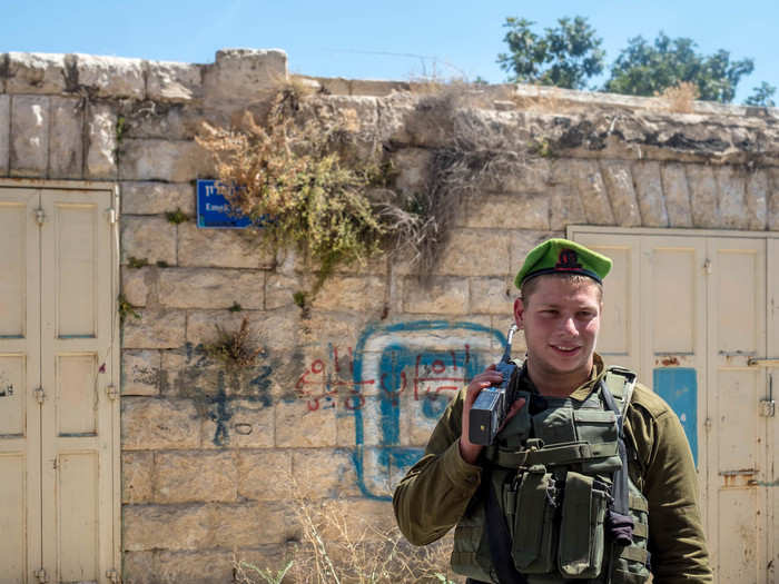 Down the road, we met an IDF soldier — an American named Asher who immigrated to Israel two years ago. Asher said that his role and the job of his unit is to "keep the peace" between Jews and Palestinians in the area, since both use the street. "We