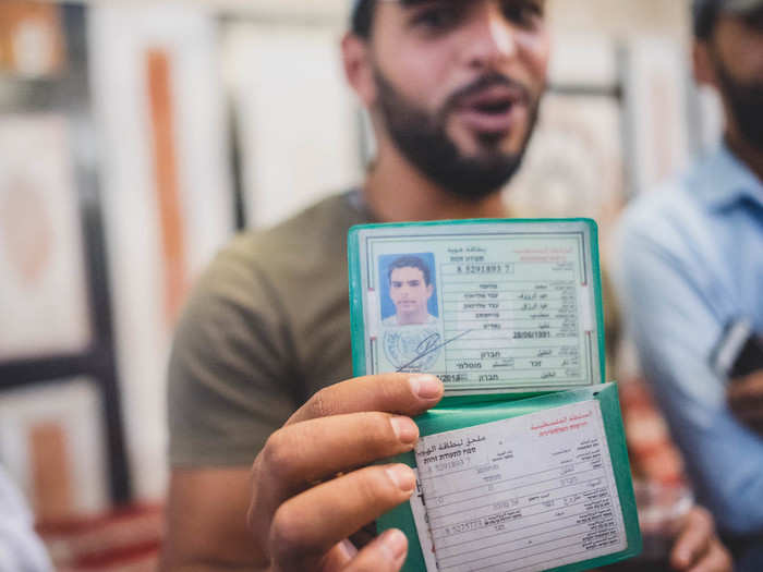 "When a curfew gets called, it only applies to us Palestinians," said Al-Mohtaseb, holding up his Palestinian ID card. "You all can visit an empty town if you like. If you want to describe Hebron in a few words: Visitors have more rights than residents."