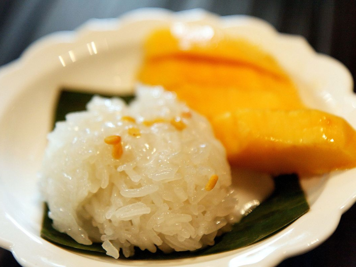 Mango sticky rice is a sugary Thai dessert mixing rice, mangoes, and coconut milk.