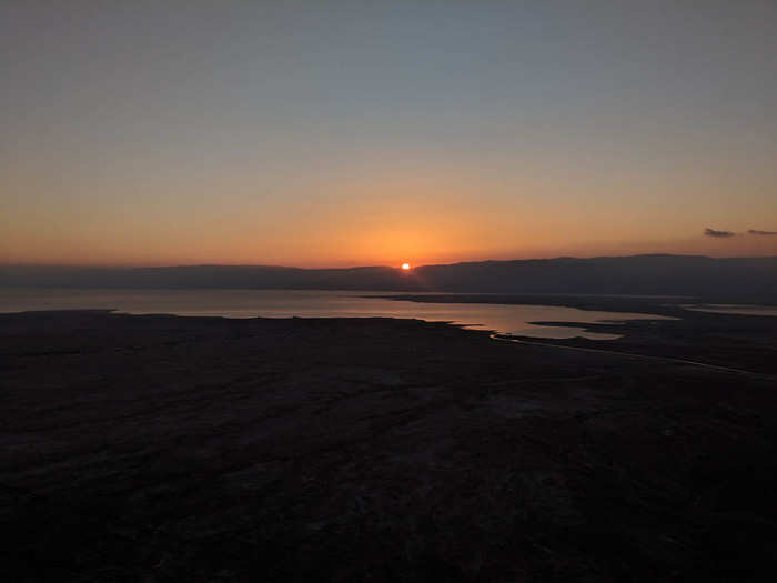 As the sun slowly rose in the east, the valley below and the Dead Sea lit up — the first glimpse at the vast, gorgeous landscape we drove through in total darkness.