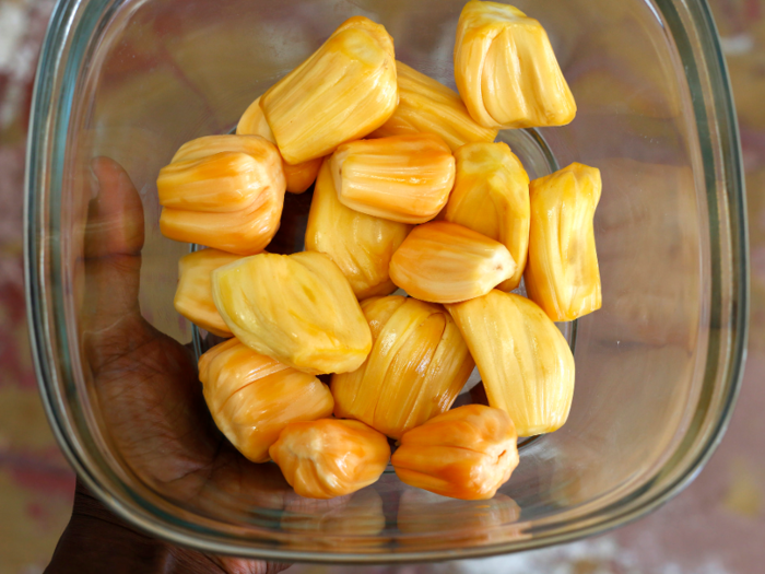 The inside of a jackfruit contains dozens of pods of thick, chewy flesh — it