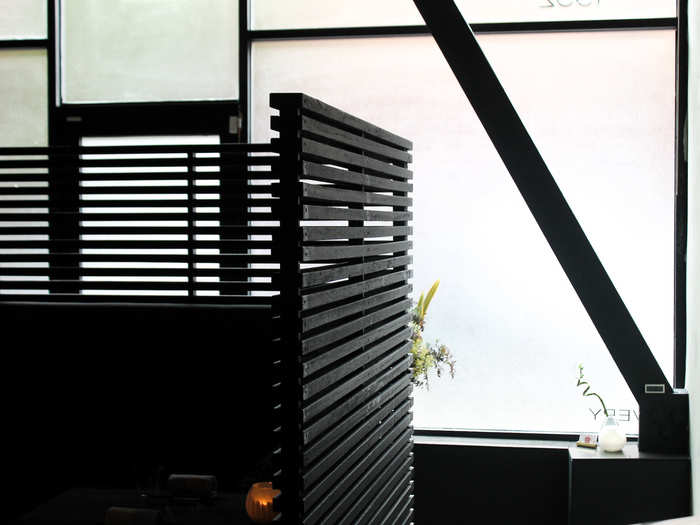 The entry way features a black slatted wall. We were seated behind it, in a cozy booth.