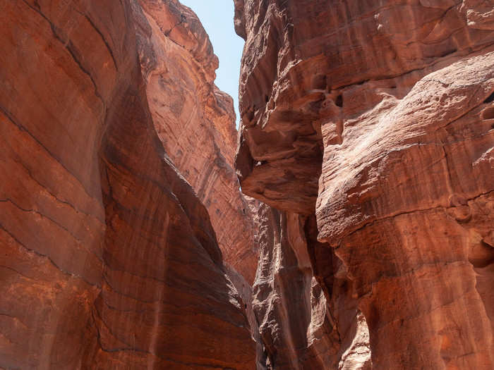 While most of the Siq is a natural rock formation, some parts were sculptured by the Nabataeans. But, in general, the Siq was kept narrow to keep out invading armies. The high walls around Petra, the surrounding mountains, and the winding gorge of the Siq all served as a natural defenses for those looking to raid the city. In many places, the Siq is only wide enough for two camels at a time.