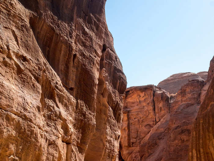 This road into the rock valley is where Petra begins. Called the Siq, the road is the ancient entrance to Petra. It is made of a split rock a little over half a mile long. Most of the rock split is a natural formation and reaches up to 250 feet in height.