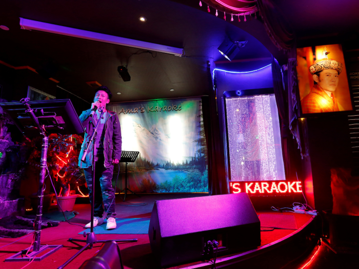 Residents stay up late in karaoke bars like this one, where customers sing traditional folk songs and the occasional Bollywood number.