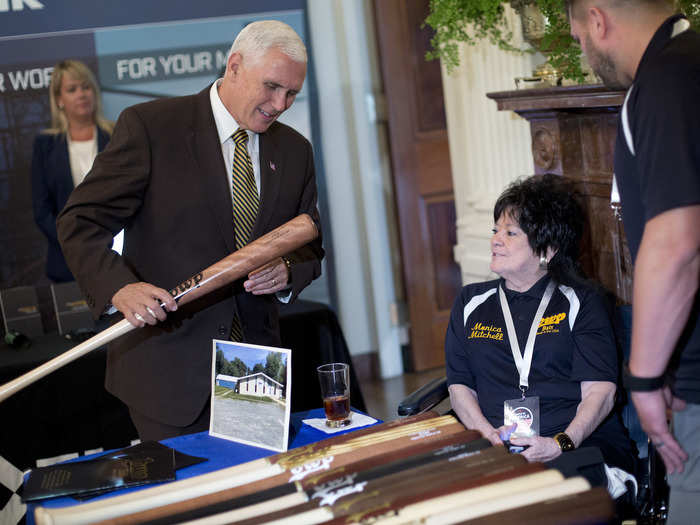 Pence inspects a bat manufactured by Pennsylvania-based BWP Baseball Bats.