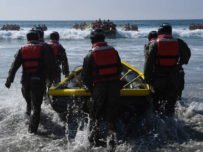 The teams bring the boat down to waist-level before they enter the water.