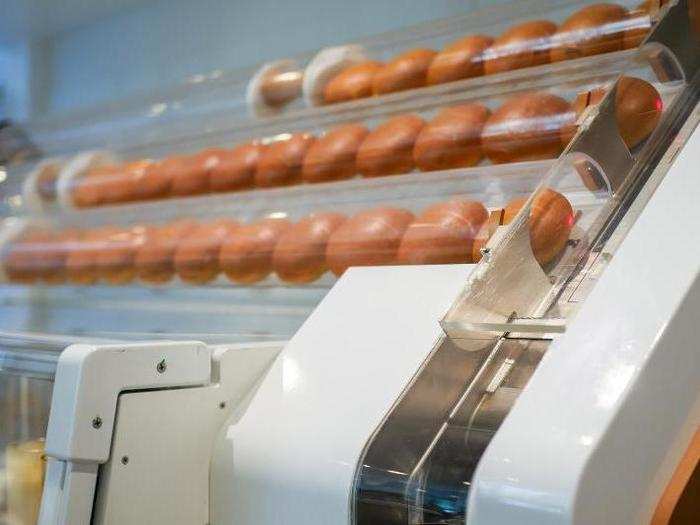 Once an order is placed, a compressed air tube pushes a brioche roll from La Boulangerie, a local bakery, into the chute at right.