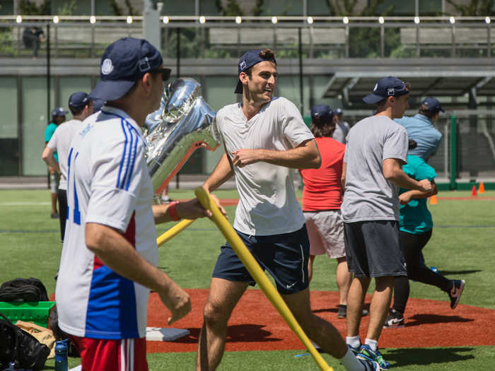 Employees grouped themselves into 120 teams divided by division. The teams play three games in pool play before advancing into the final single-elimination round of 16. Each team hits for five minutes in each game.