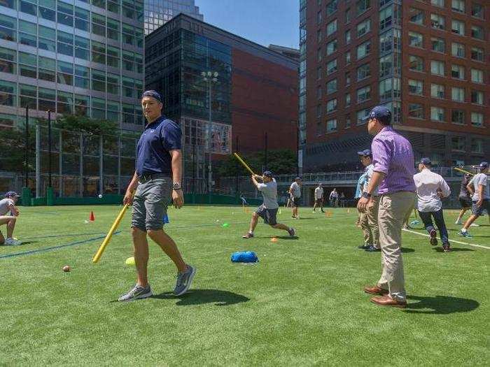 Here you can see how the field is set up. Team members pitch to each other, and they aim to hit the ball over a series of lines delineated by cones. The opposing team tries to catch the ball, or otherwise stop it.