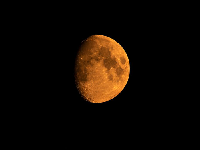 Even the view of the moon has been tinged by dark smoke.