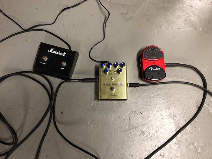 This is my current pedal situation, with the Pugilist dropped in for contrast. The footswitch on the left goes into my 50-watt Marshall DFX amp. I can switch from clean to dirty tones and turn the built-in effects on and off. The OTHER pedal is actually an old Fender in-line tuner. That