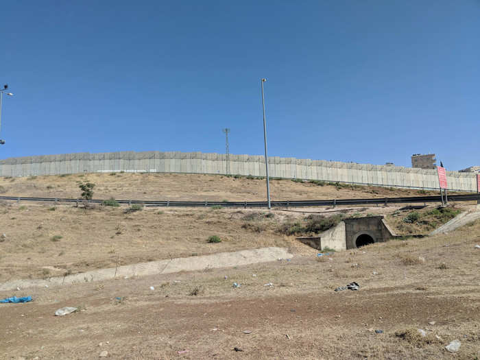 The wall, when complete, is expected to run 440 miles. The sections with concrete can reach as high as 28 feet, and are routinely topped with barbed wire.