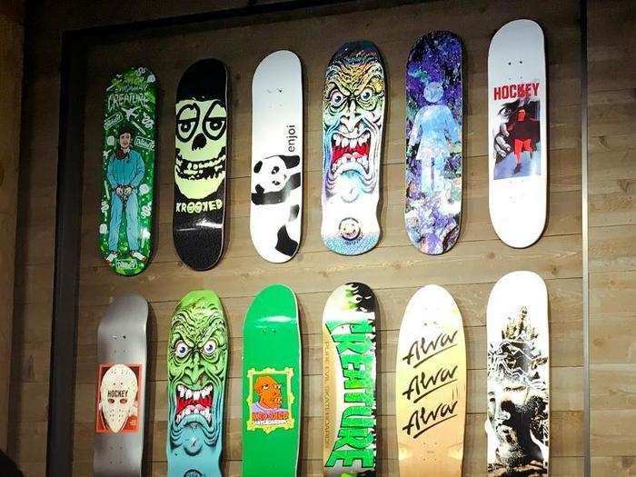 There was a wall of skateboards for sale from popular brands like Hockey, Krooked, and enjoi.