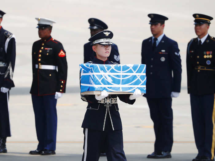 A soldier carries a casket containing the remains of a US soldier who was killed in the Korean War during a ceremony at Osan Air Base in Pyeongtaek, South Korea, July 27, 2018.