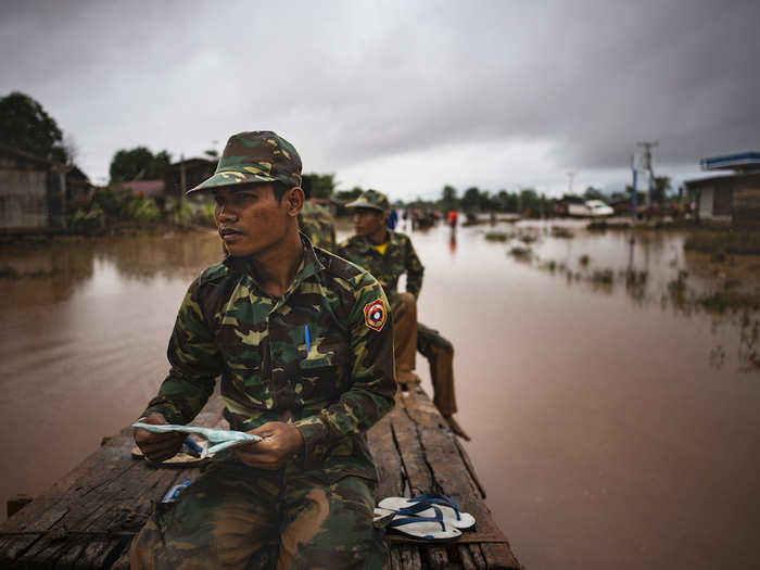 Soldiers make their way to affected villages after flash floods engulfed these several villages, on July 26, 2018 in Attepeu, southeastern Laos. At least 26 people were killed and over 3,000 people stranded after a hydroelectric dam built collapsed in southeastern Laos, destroying thousands of homes and leaving an unknown number of dead.