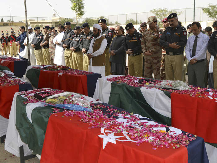 Pakistan Elections People attend funeral of suicide bombing victims in Quetta, Pakistan, Wednesday, July 25, 2018. A suicide bomber on a motorcycle rammed into people waiting outside a busy polling station in Quetta on Wednesday, killing dozens of people, casting a dark shadow on what was to be a historic day for the country as Pakistanis cast ballots to elect their thirds consecutive civilian government.