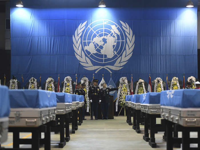 The remains were transferred from the boxes they arrived in to full-sized caskets draped with UN flags.