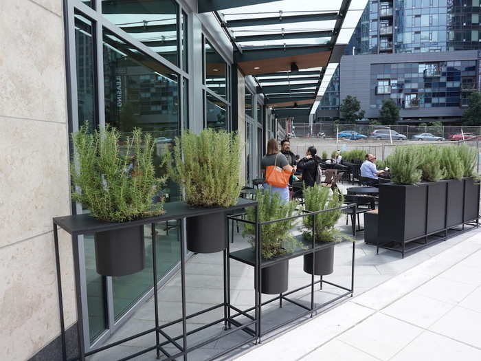 An outdoor seating area lined with rosemary plants is great for soaking up the last warm days of Seattle summer, though nearby construction makes it a bit noisy.