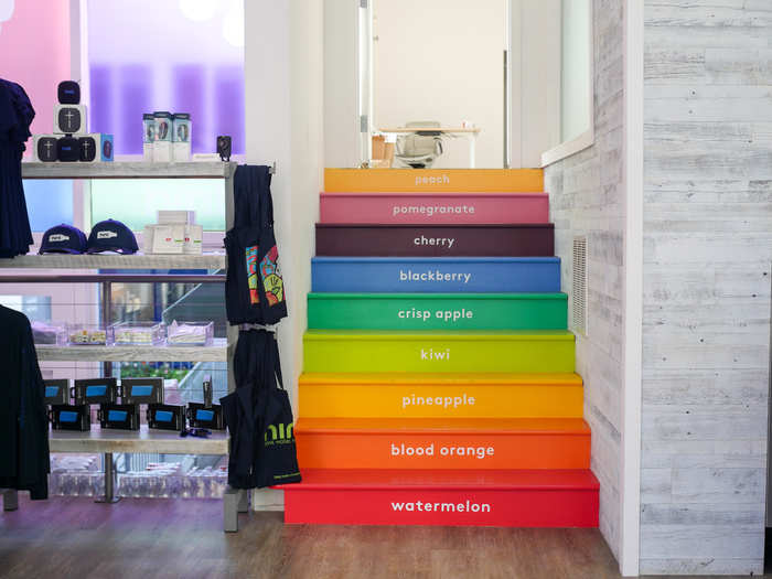 A rainbow-colored staircase leads to the back office of the flagship store.