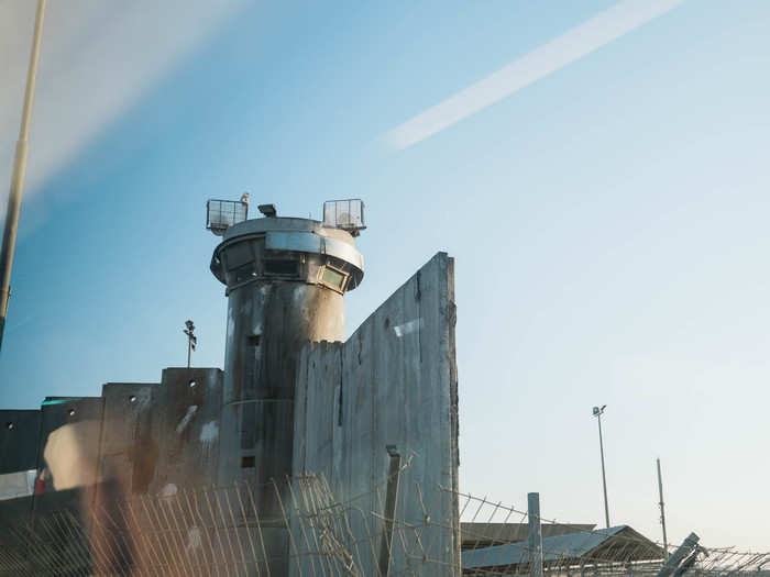 There are massive guard towers to keep watch through the checkpoint. Four different Israeli groups run the checkpoint — the IDF, Israeli police, the IDF Civil Administration (the military/civilian administrative body that oversees life in the West Bank), and private security guards hired by the Defense Ministry.