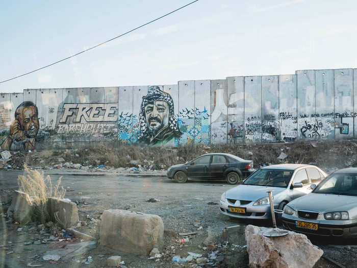 One of the most iconic graffiti paintings on the wall is this portrait of Yasser Arafat, the famous Palestinian political leader. Depending on how fast the line is going, getting through the checkpoint can take several hours.