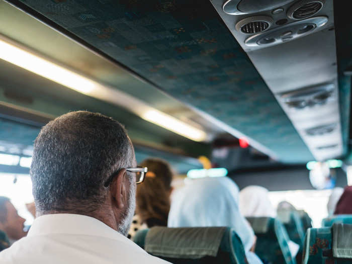 When we came into view of the checkpoint, the bus stopped so that more people could get on. About 20 people filled the bus, to the point where there were a few people standing in the aisle.