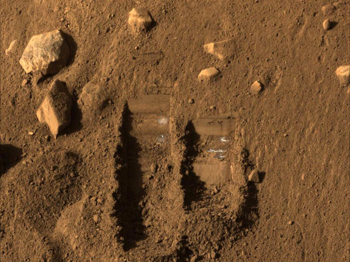 The Phoenix lander, which was active from May to November of 2008, used its robotic arm to dig these two trenches to check soil samples.