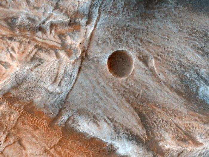 The flowing features in the terrain at Mars’ middle latitudes could have once been formed by water and ice. Orbiter sent this image back in 2017.