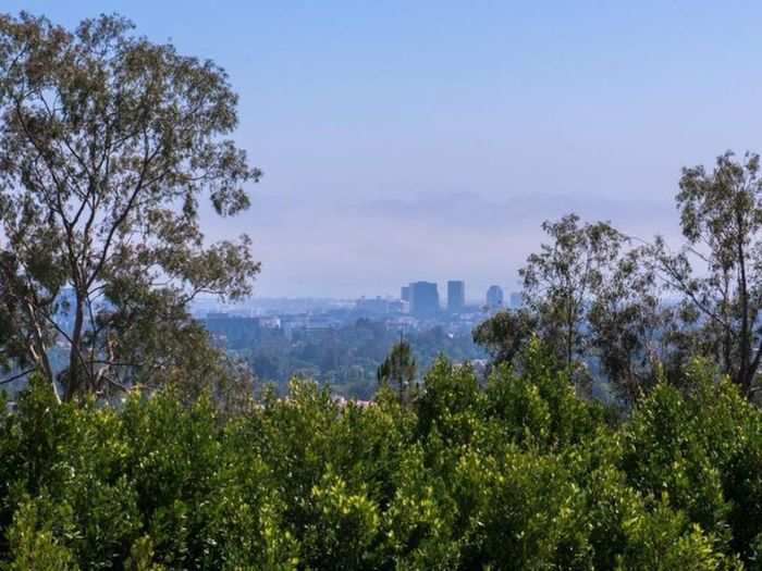 The traditional-style home sits on two acres of secluded land and boasts views of downtown Los Angeles and the Pacific ocean.