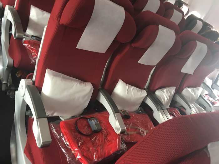 At every seat, there is a blanket, a pillow, and a pair of headphones. My past trans-Atlantic trips with VA also featured small economy class amenity kits. However, I did not receive one on either of my flights.